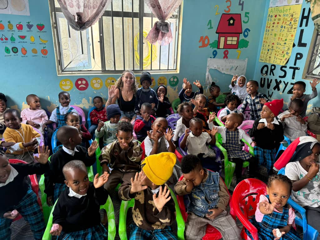 Children smiling in the Rose Flower Daycare classroom